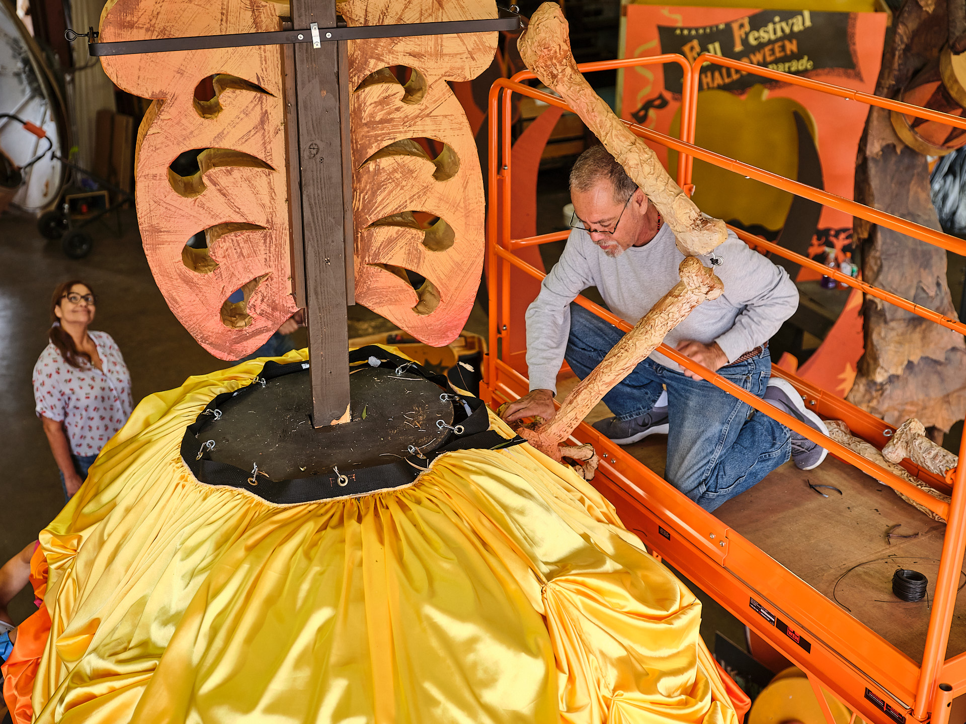 An volunteer assembles details on a float.