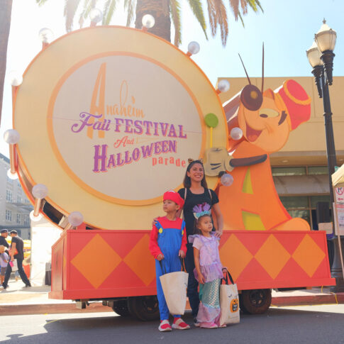 A pamIly poses for a photo in front of our beloved Andy Anaheim float.