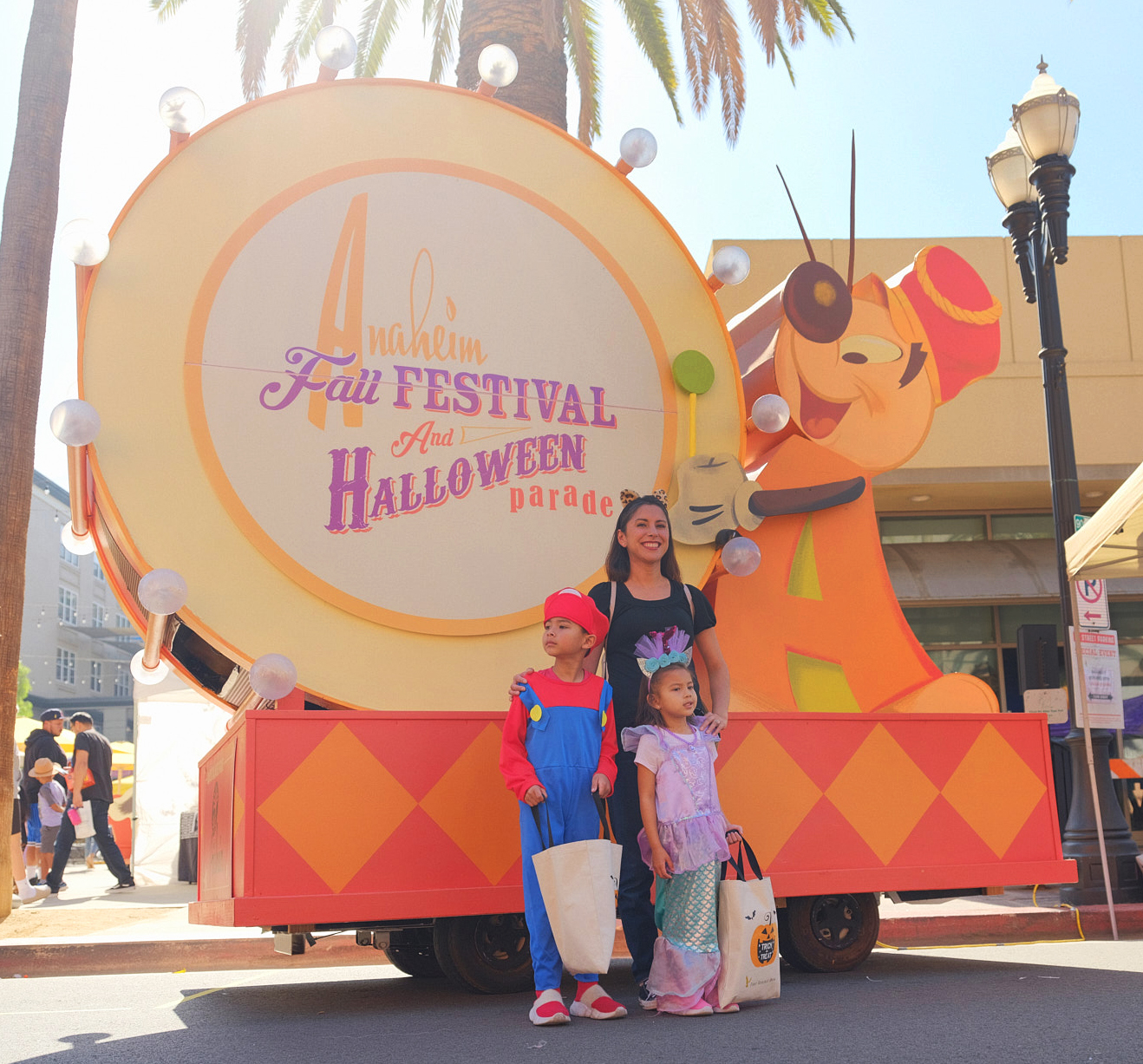 A pamIly poses for a photo in front of our beloved Andy Anaheim float.