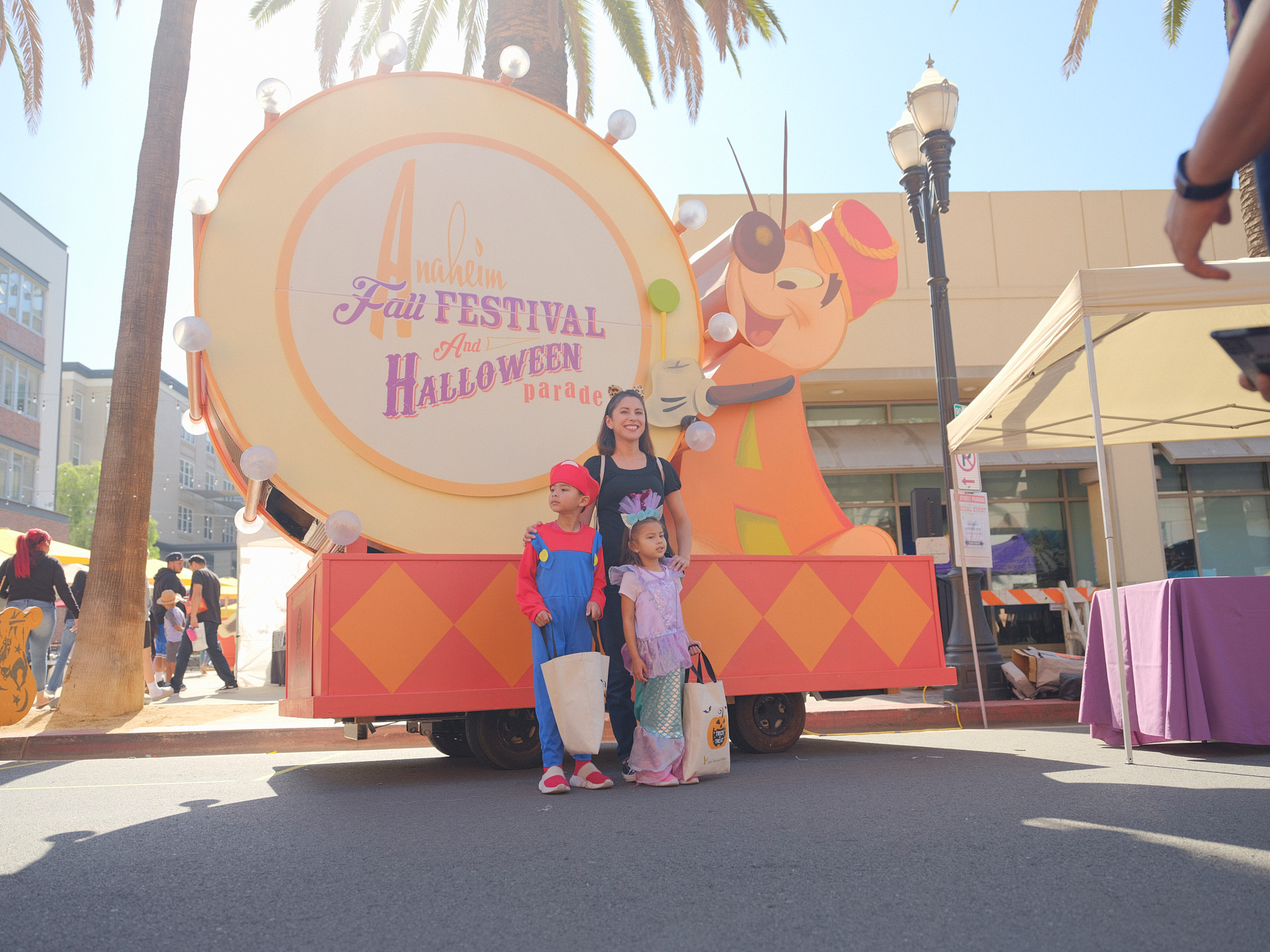 A pamIly poses for a photo in front of our beloved Andy Anaheim float.